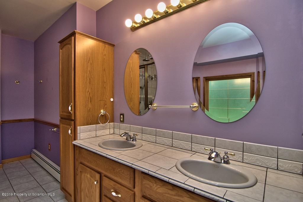 16 Pine Ridge Road Tunkhannock, PA 18657 - Photo 42 of 86 a bathroom with a double vanity sink and a mirror
