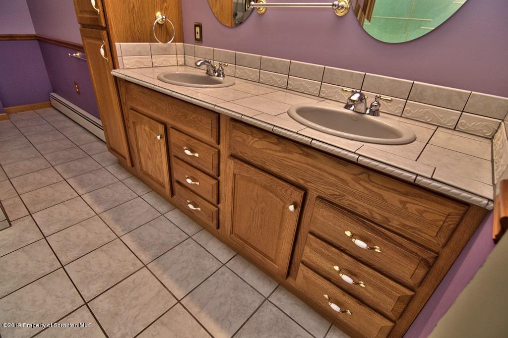 16 Pine Ridge Road Tunkhannock, PA 18657 - Photo 43 of 86 a bathroom with a double vanity sink and a mirror
