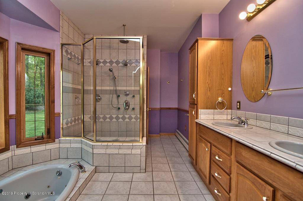 16 Pine Ridge Road Tunkhannock, PA 18657 - Photo 44 of 86 a bathroom with a double vanity sink mirror and bathtub
