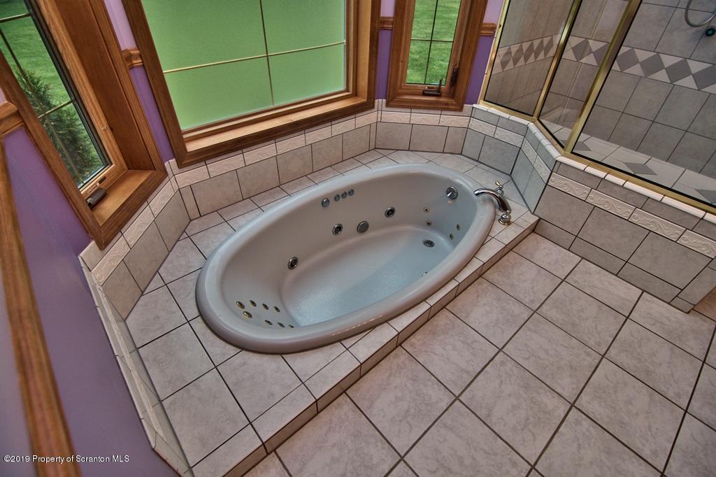 16 Pine Ridge Road Tunkhannock, PA 18657 - Photo 46 of 86 a bathroom with a bathtub and next to a window