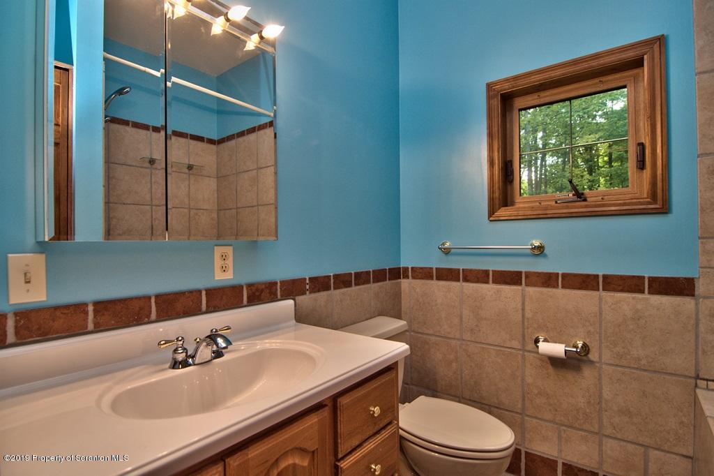 16 Pine Ridge Road Tunkhannock, PA 18657 - Photo 51 of 86 a bathroom with a sink a toilet and mirror
