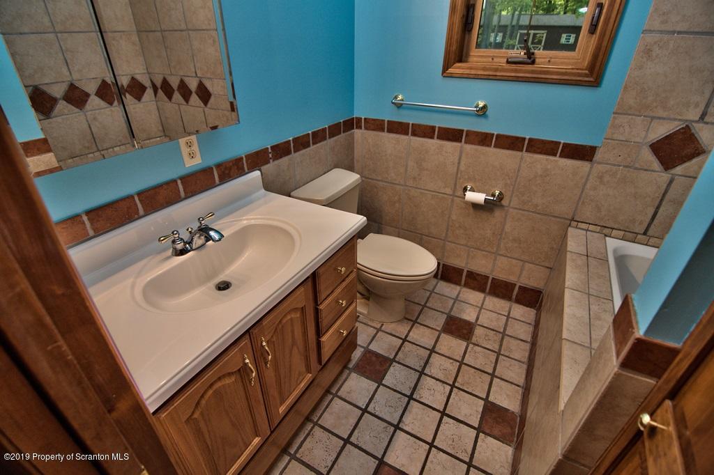 16 Pine Ridge Road Tunkhannock, PA 18657 - Photo 52 of 86 a bathroom with a sink and a mirror