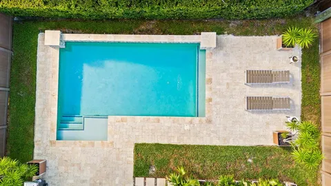 front view of a brick house with a yard