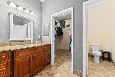 a bathroom with a toilet sink and a mirror