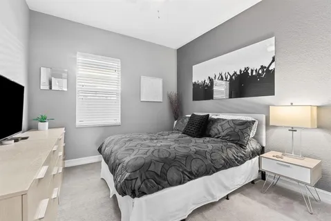 a bedroom with a bed and lamp