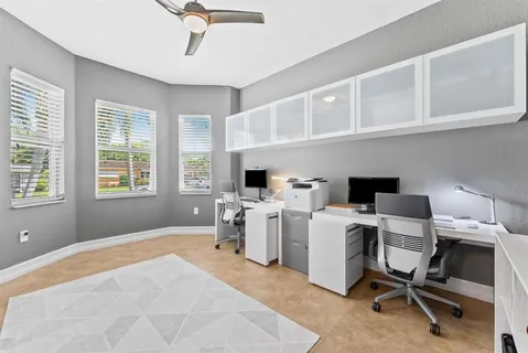 a view of a workspace with furniture and windows