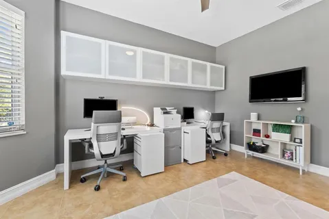 a view of a livingroom with workspace and a window