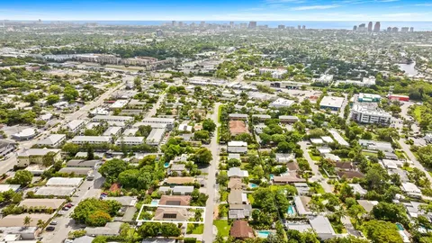an aerial view of residential houses with city view