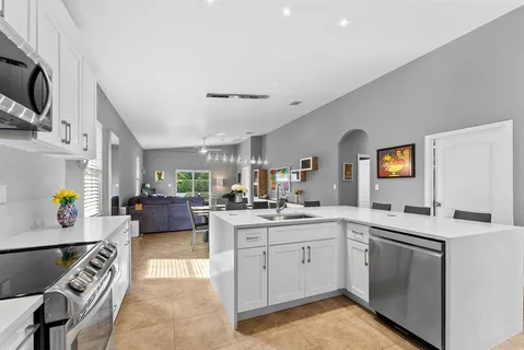 a kitchen with a sink stove and cabinets