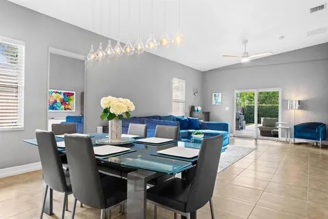 a view of a dining room with furniture and chandelier