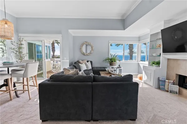 a living room with fireplace furniture and a flat screen tv