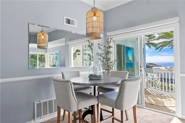 a dining room with furniture a chandelier and wooden floor