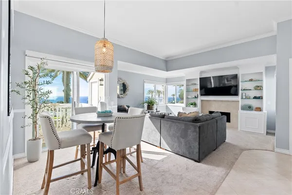 a dining room with furniture a flat screen tv and a chandelier