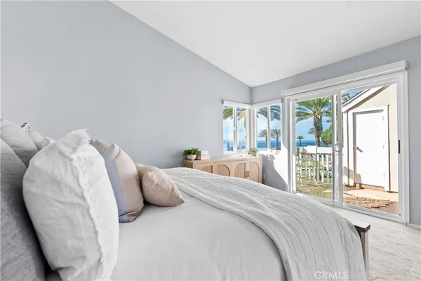 a large bed sitting in a bedroom next to a large window