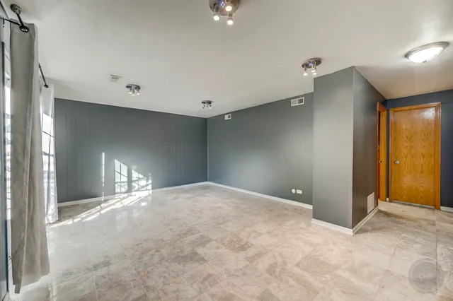 an empty room with furniture and a window