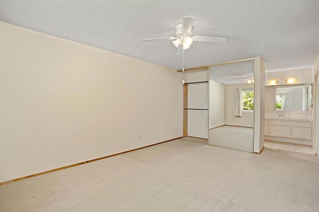 4202 Dawn Lane Oceanside, CA 92056 - Photo 12 of 23 an empty room with chandelier fan and refrigerator