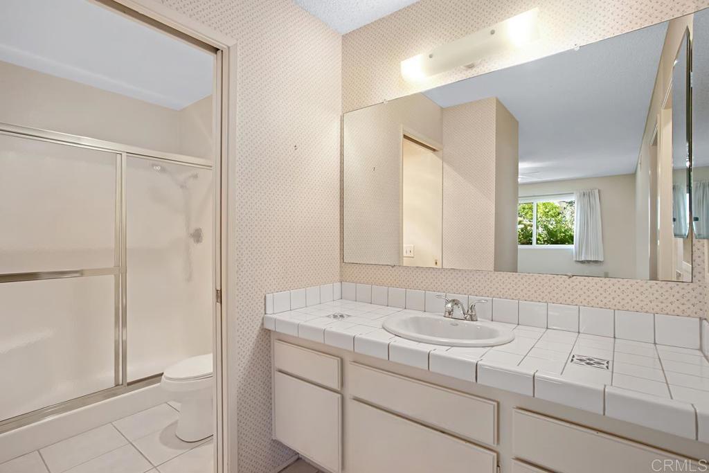 4202 Dawn Lane Oceanside, CA 92056 - Photo 13 of 23 a bathroom with a sink and a mirror