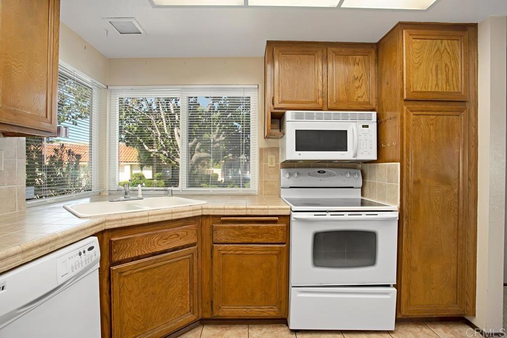 4202 Dawn Lane Oceanside, CA 92056 - Photo 8 of 23 a kitchen with cabinets stainless steel appliances and a sink