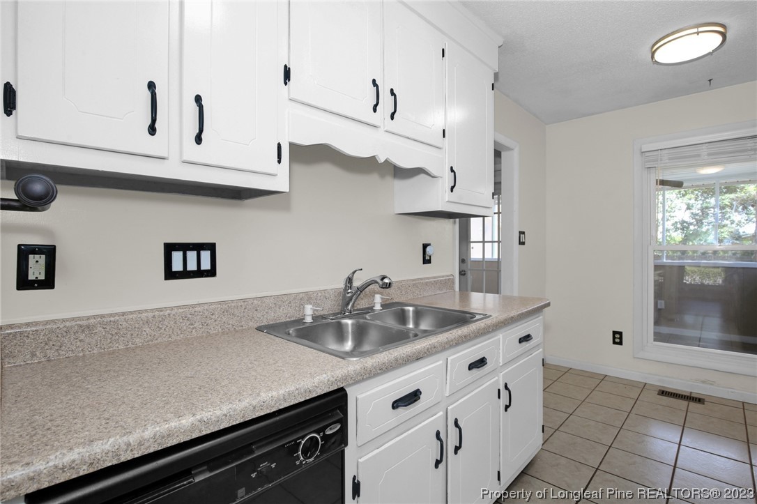 3675 Applegate Road Hope Mills, NC 28348 - Photo 11 of 32 a kitchen with stainless steel appliances granite countertop a sink and white cabinets
