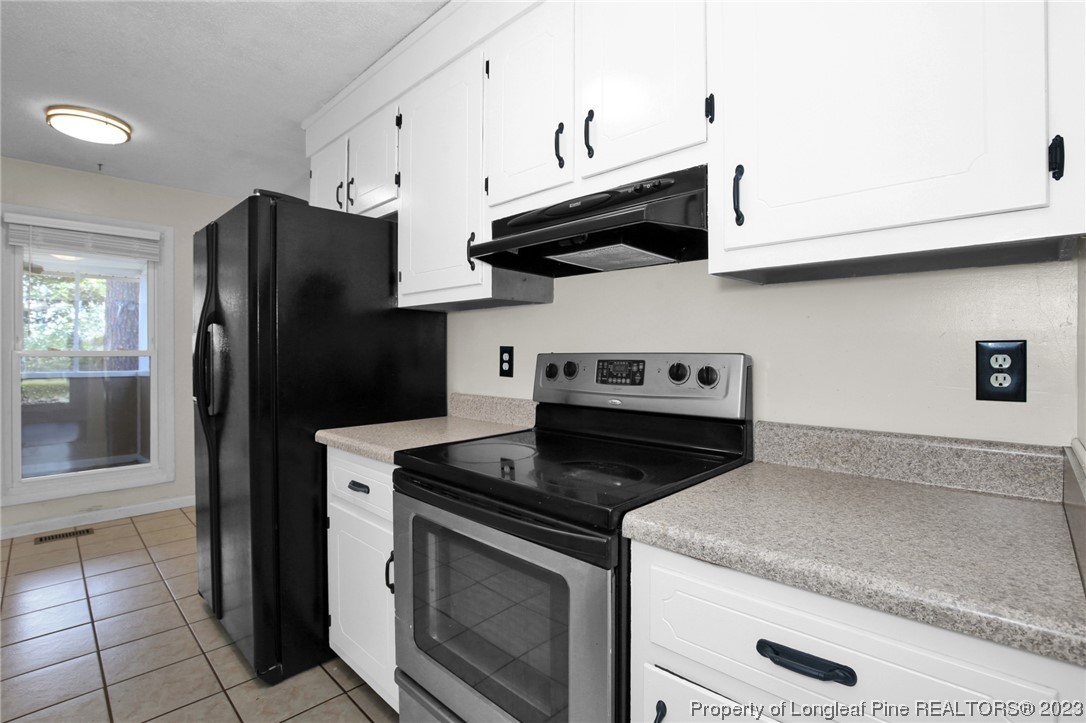3675 Applegate Road Hope Mills, NC 28348 - Photo 12 of 32 a kitchen with stainless steel appliances granite countertop white cabinets a refrigerator and a stove