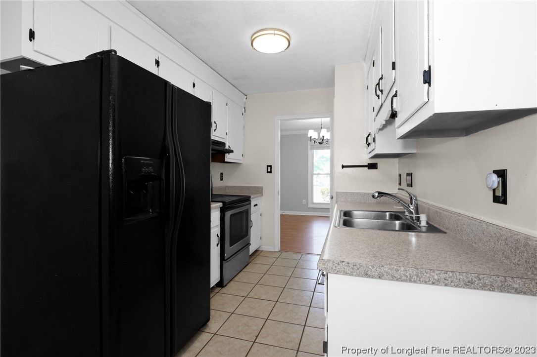 3675 Applegate Road Hope Mills, NC 28348 - Photo 13 of 32 a kitchen with granite countertop a refrigerator and a sink