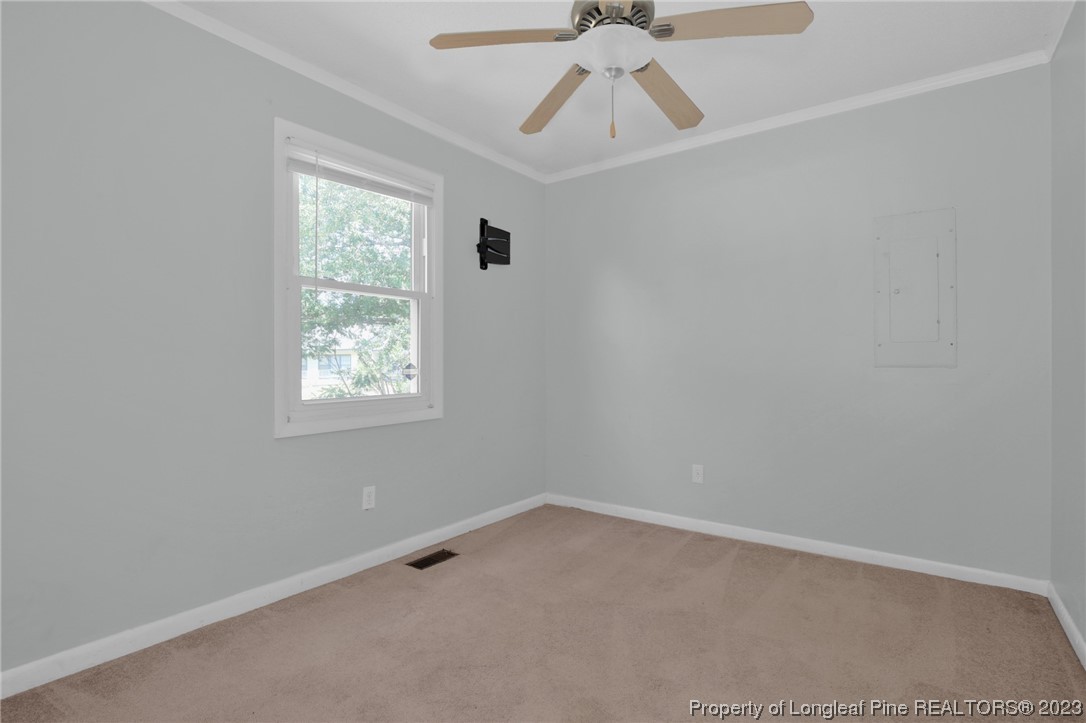 3675 Applegate Road Hope Mills, NC 28348 - Photo 20 of 32 an empty room with a window and a fan