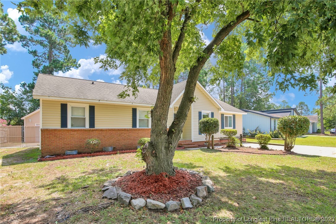 3675 Applegate Road Hope Mills, NC 28348 - Photo 3 of 32 a front view of a house with garden