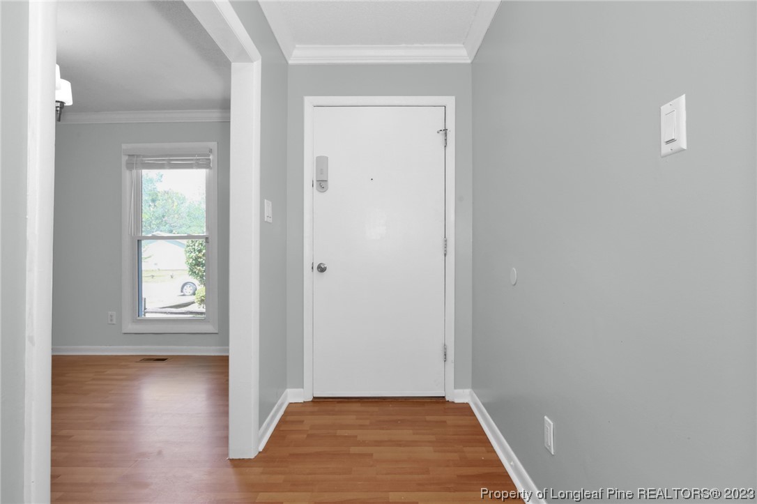 3675 Applegate Road Hope Mills, NC 28348 - Photo 4 of 32 an empty room with wooden floor and windows