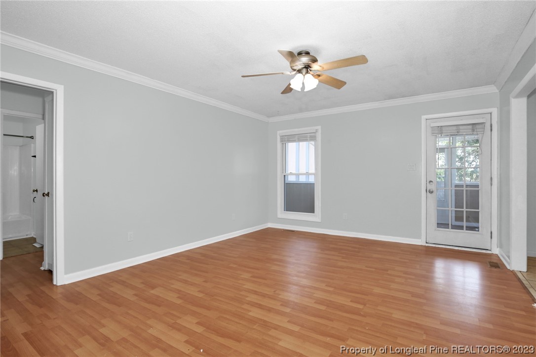 3675 Applegate Road Hope Mills, NC 28348 - Photo 7 of 32 a view of an empty room with wooden floor and a window