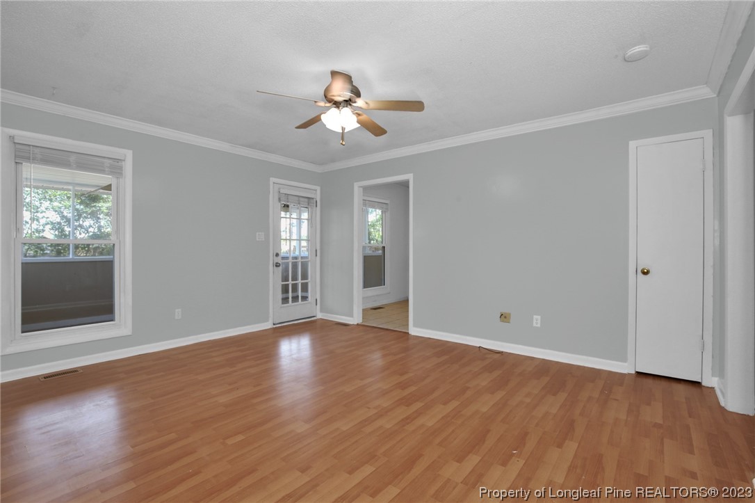 3675 Applegate Road Hope Mills, NC 28348 - Photo 8 of 32 a view of an empty room with wooden floor and a window