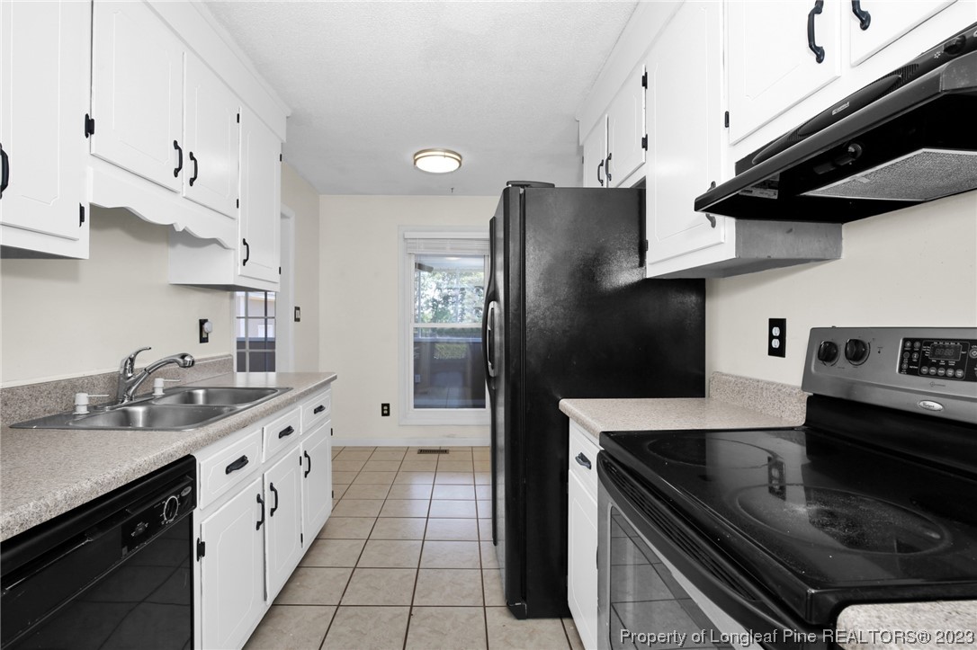 3675 Applegate Road Hope Mills, NC 28348 - Photo 10 of 32 a kitchen with stainless steel appliances a sink stove and cabinets