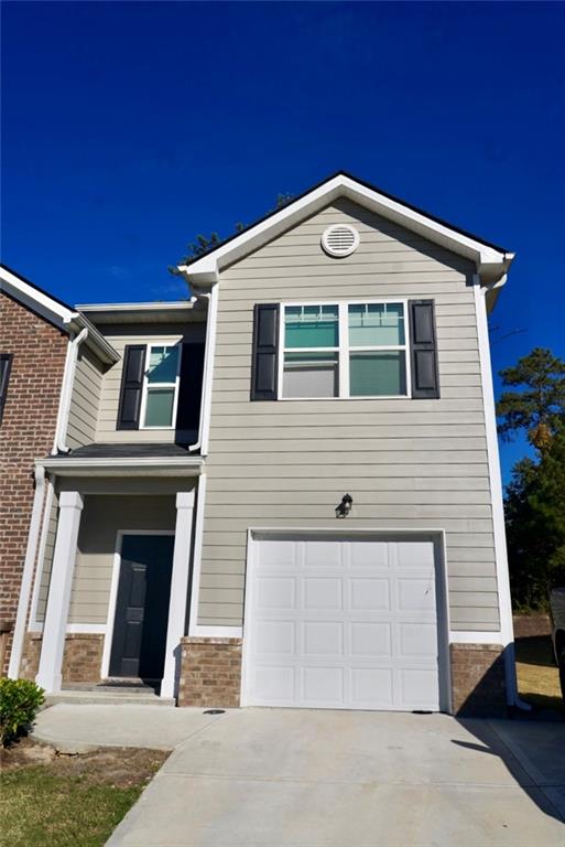 6258 Rockaway Road Atlanta, GA 30349 - Photo 1 of 1 a front view of a house with a garage