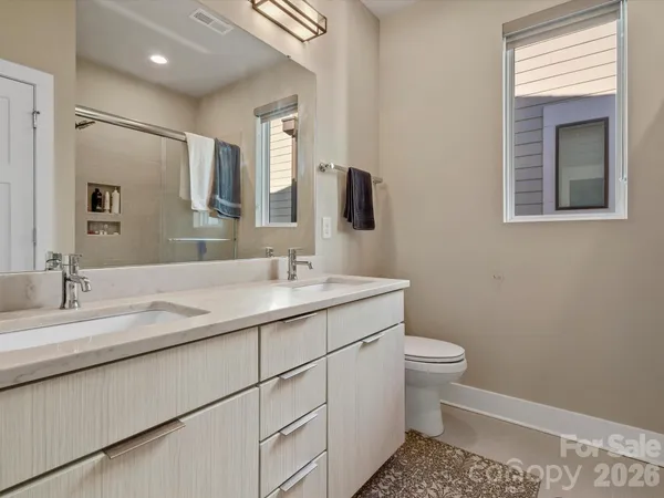a bathroom with a sink toilet and mirror