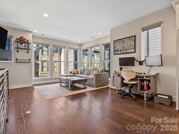 a view of a livingroom with workspace and a window