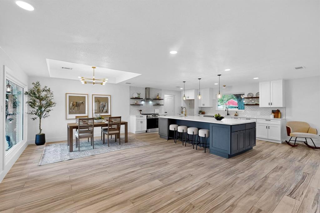 1808 Greenwood Road McKinney, TX 75069 - Photo 12 of 40 a large room with stainless steel appliances kitchen island granite countertop a large counter top and chairs