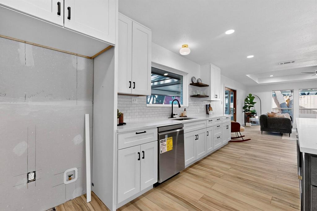 1808 Greenwood Road McKinney, TX 75069 - Photo 15 of 40 a large kitchen with stainless steel appliances granite countertop a lot of counter space and wooden floor