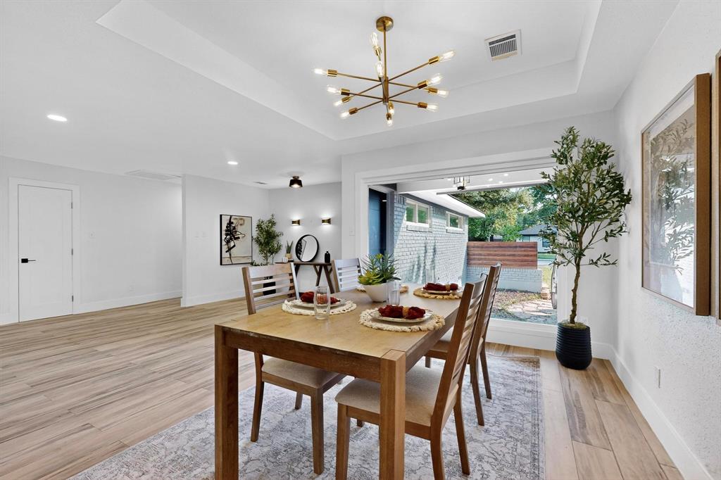 1808 Greenwood Road McKinney, TX 75069 - Photo 17 of 40 a view of a dining room with furniture and wooden floor