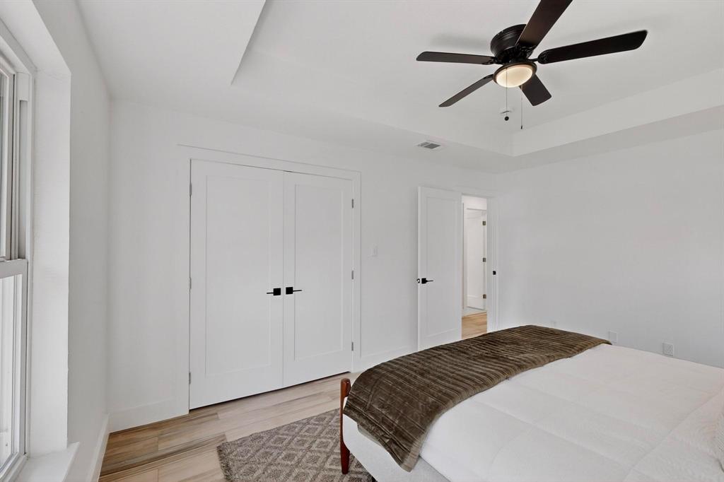 1808 Greenwood Road McKinney, TX 75069 - Photo 20 of 40 a bedroom with a bed and a ceiling fan