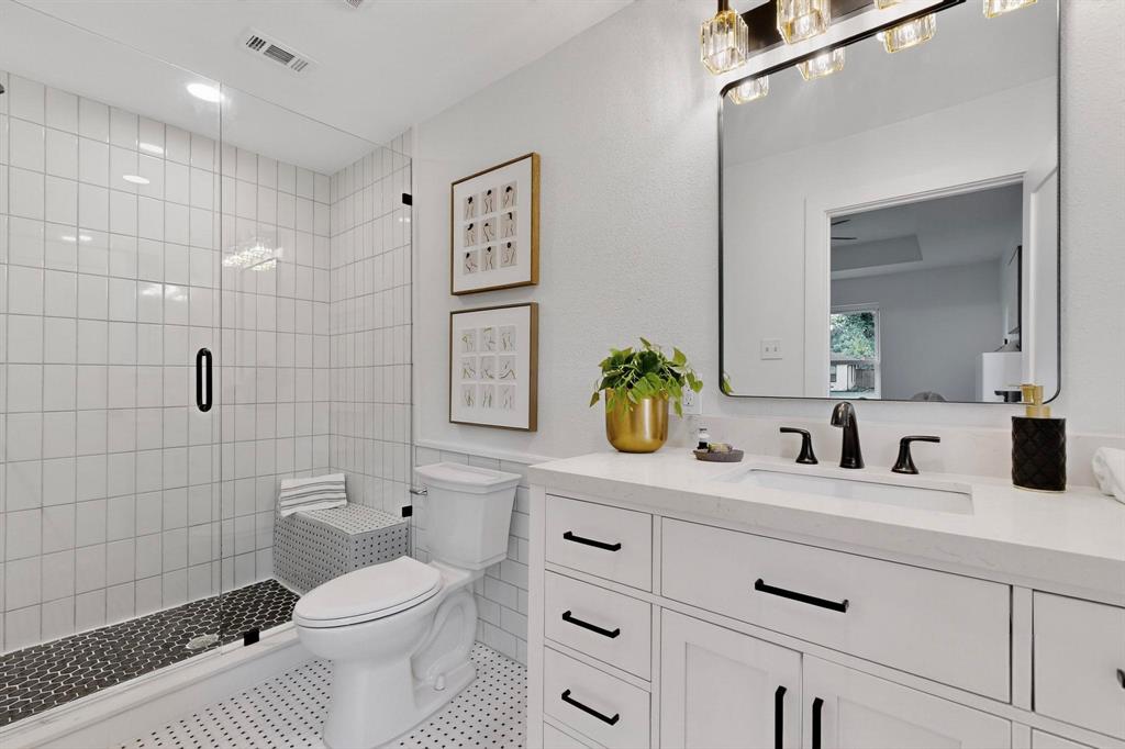 1808 Greenwood Road McKinney, TX 75069 - Photo 22 of 40 a bathroom with a toilet sink and shower