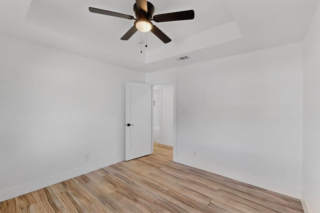 1808 Greenwood Road McKinney, TX 75069 - Photo 27 of 40 an empty room with a window and a fan