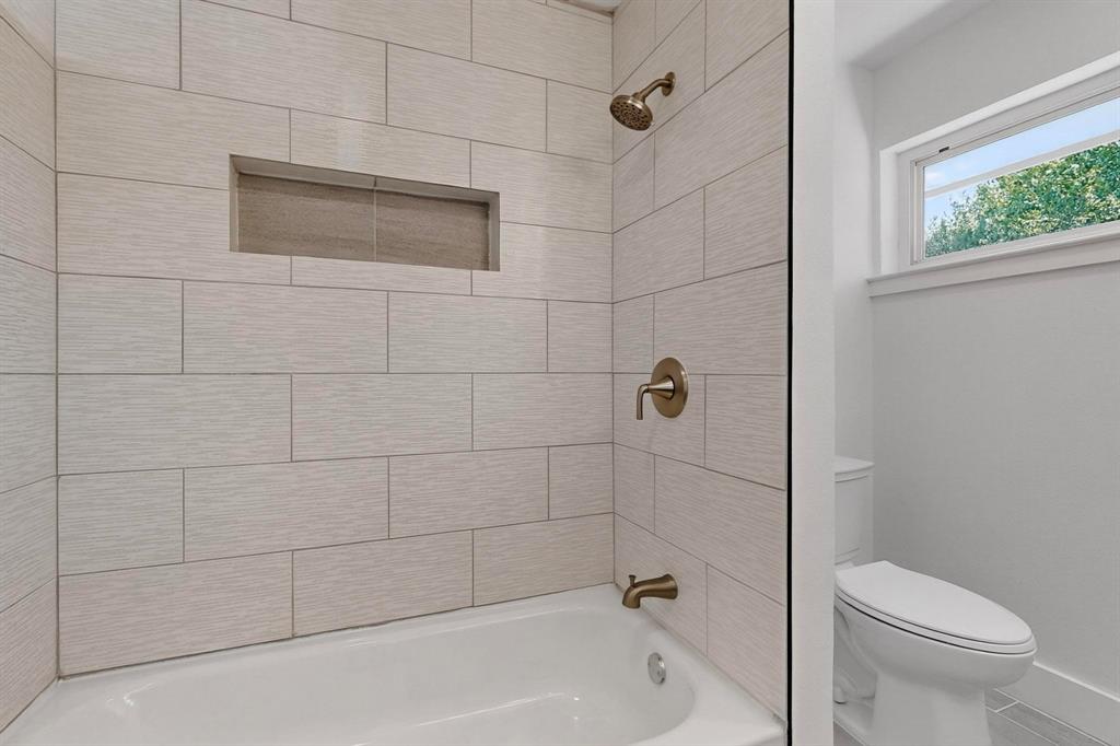 1808 Greenwood Road McKinney, TX 75069 - Photo 30 of 40 a bathroom with a shower a toilet and a bathtub