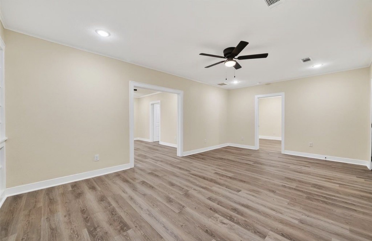 2725 Avenue F Rosenberg, TX 77471 - Photo 11 of 17 wooden floor in an empty room with a window