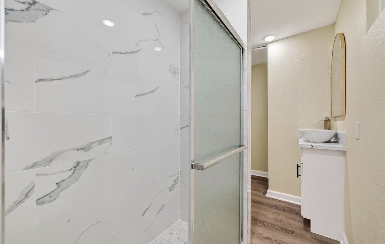 2725 Avenue F Rosenberg, TX 77471 - Photo 12 of 17 a bathroom with a shower and a sink