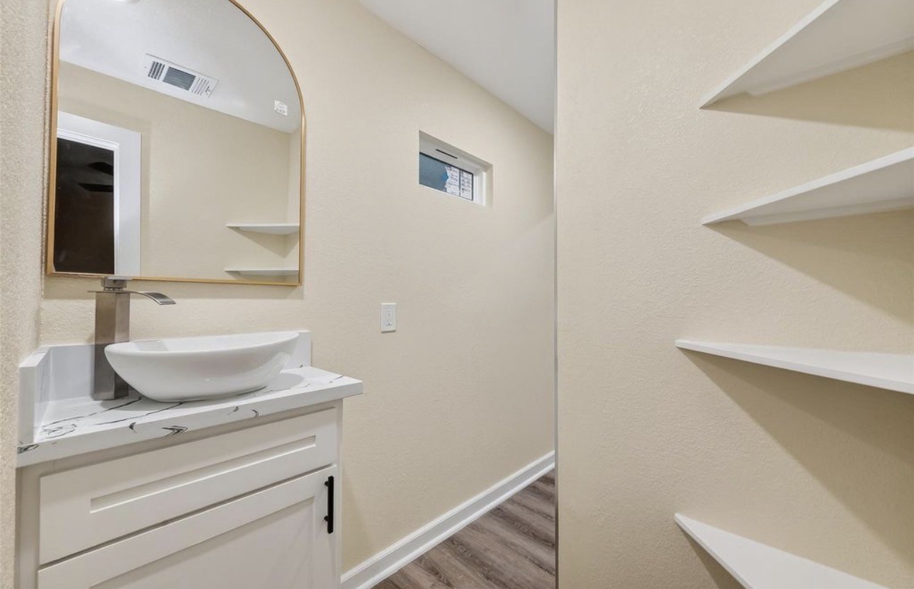 2725 Avenue F Rosenberg, TX 77471 - Photo 13 of 17 a bathroom with a sink and a mirror