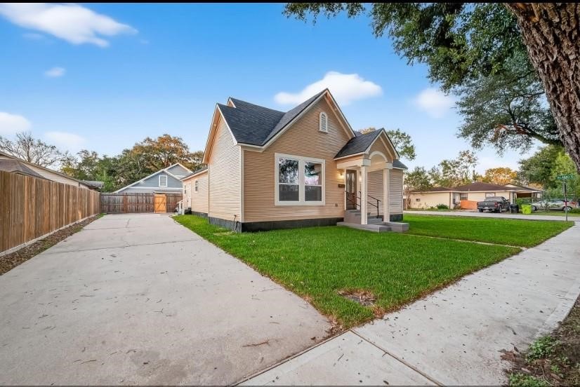 2725 Avenue F Rosenberg, TX 77471 - Photo 2 of 17 a view of a house with a big yard plants and large trees