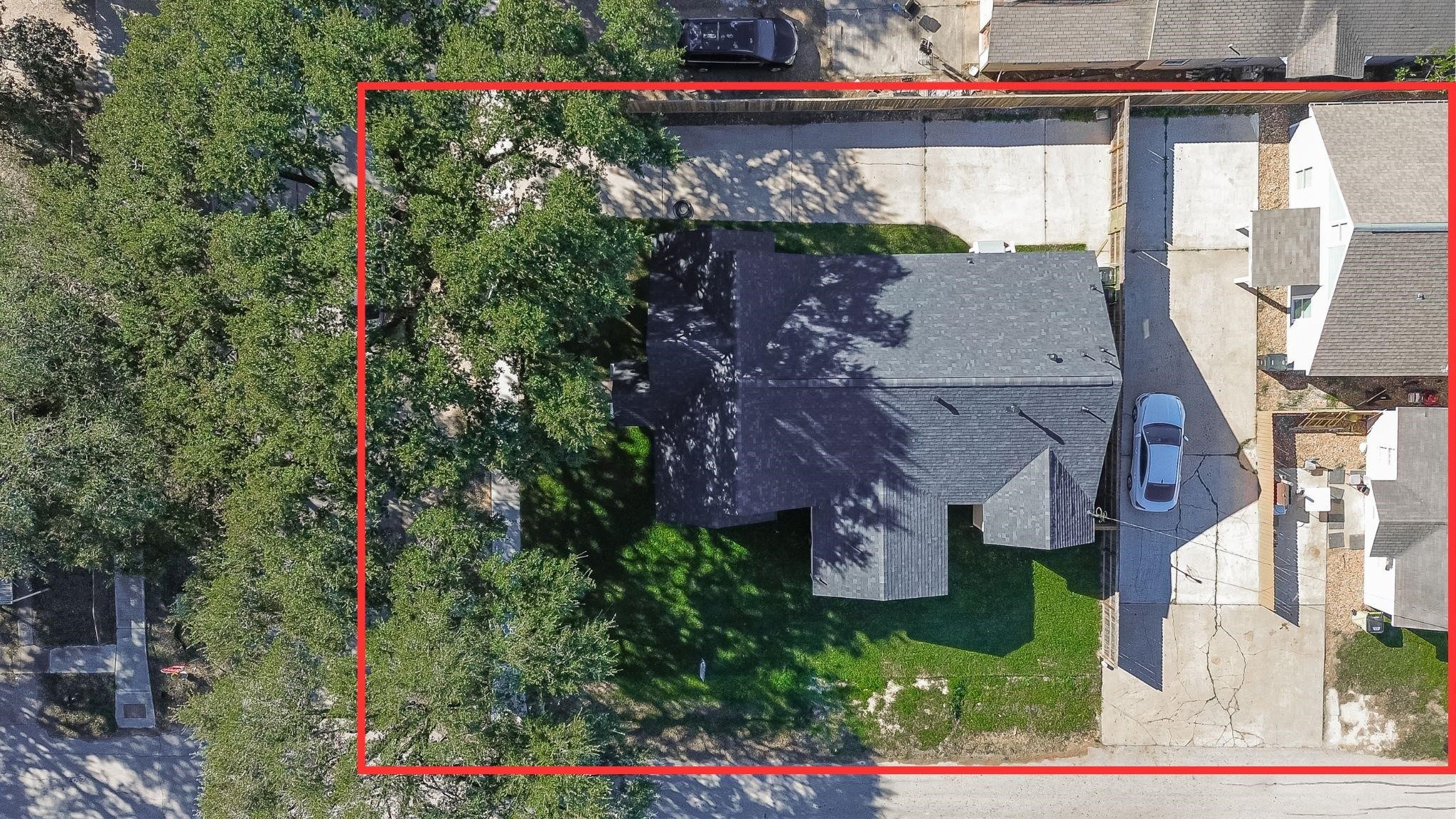 2725 Avenue F Rosenberg, TX 77471 - Photo 3 of 17 an aerial view of a house with a yard and large trees