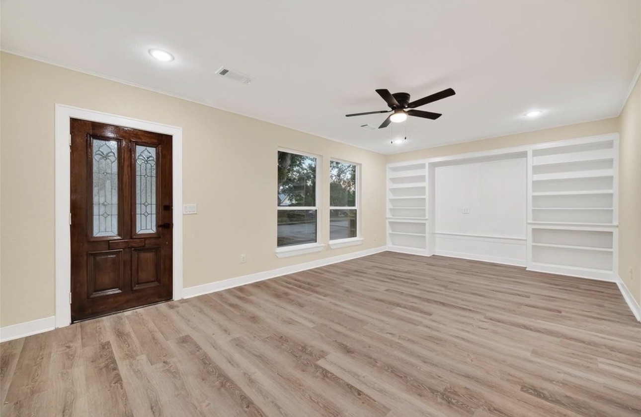2725 Avenue F Rosenberg, TX 77471 - Photo 4 of 17 a view of an empty room with a window and a kitchen