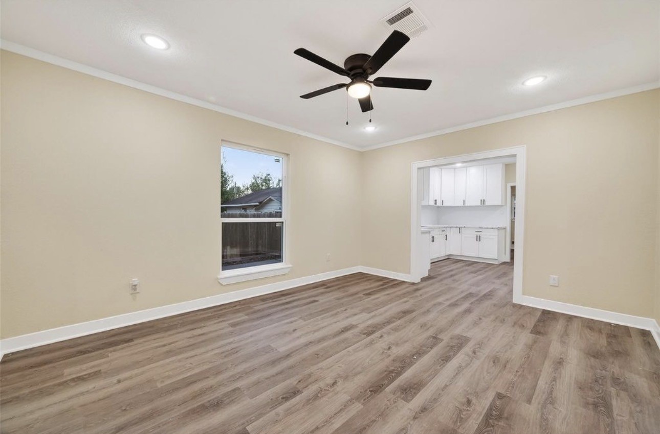 2725 Avenue F Rosenberg, TX 77471 - Photo 6 of 17 wooden floor in an empty room with a window