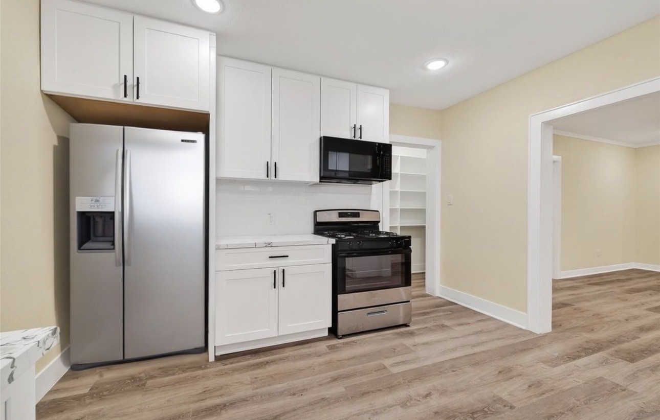 2725 Avenue F Rosenberg, TX 77471 - Photo 8 of 17 a kitchen with a refrigerator stove and a sink