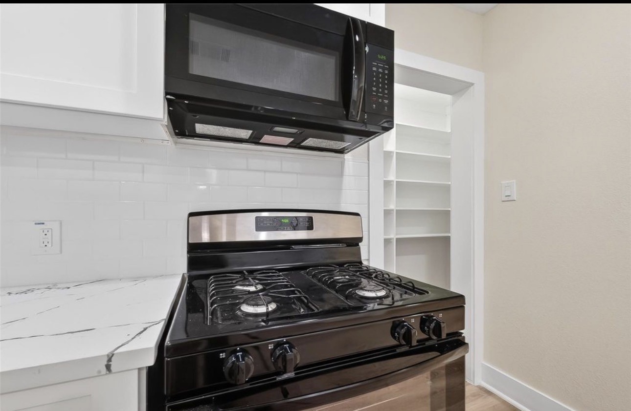 2725 Avenue F Rosenberg, TX 77471 - Photo 9 of 17 a stove top oven sitting inside of a kitchen